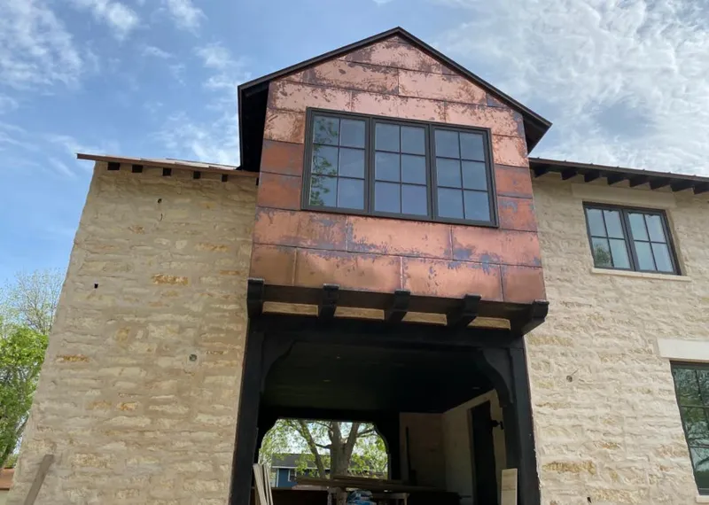 Copper metal panel facade on a stone building for Skylight Installation in Downers Grove